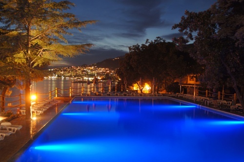 Outdoor pool illuminated at night at Sun Resort